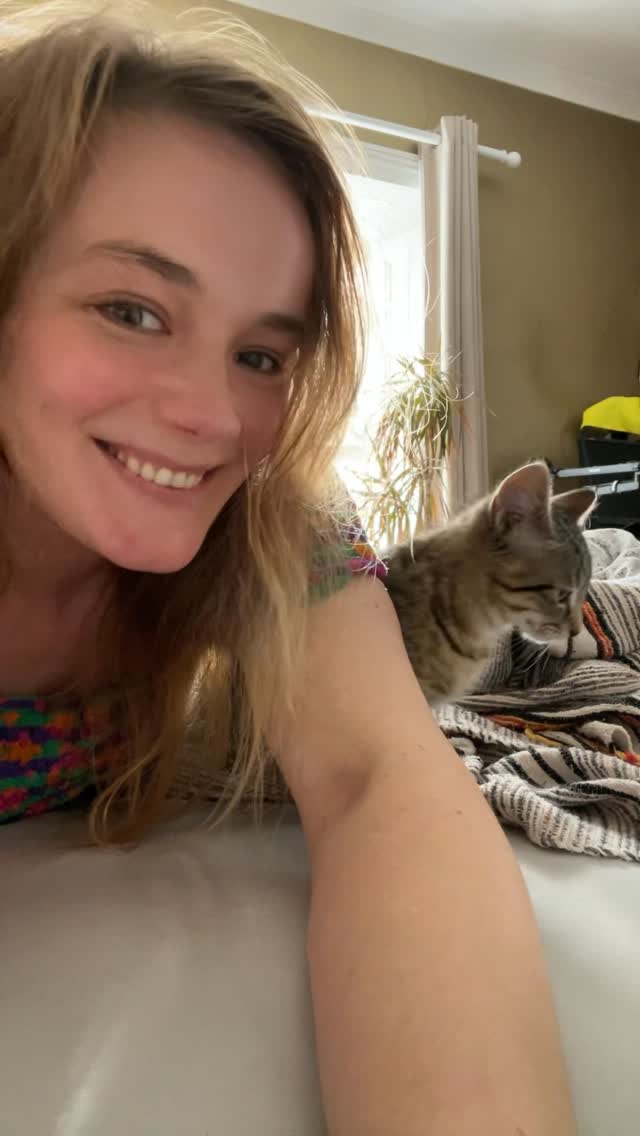 Me beside Mika, a tabby rescue cat, at home.
